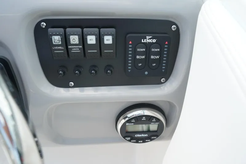 Slide: The Image of Control panel of 2025 Robalo R207 Dual Console boat with switches and Lenco trim tab controls. - 16