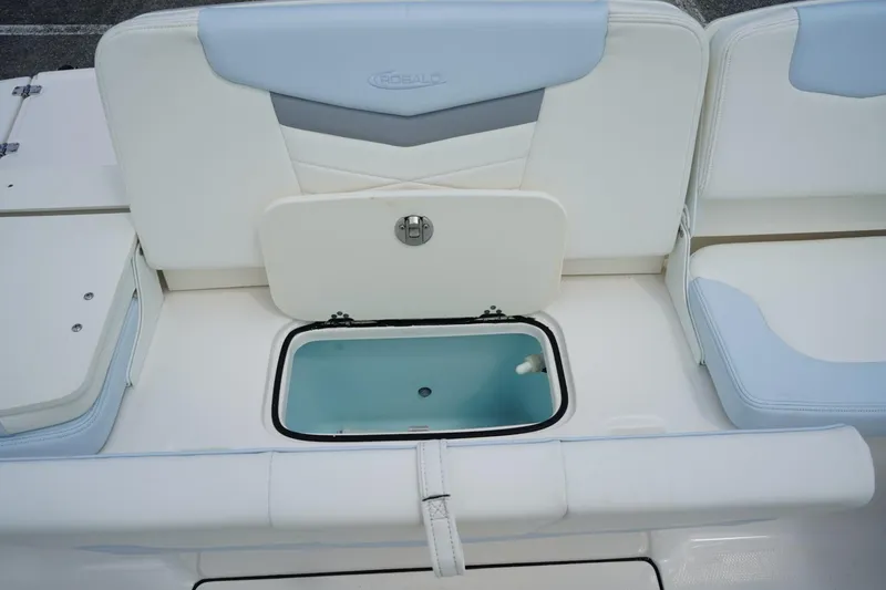 Slide: The Image of 2025 Robalo R207 Dual Console boat interior with open storage compartment. - 11