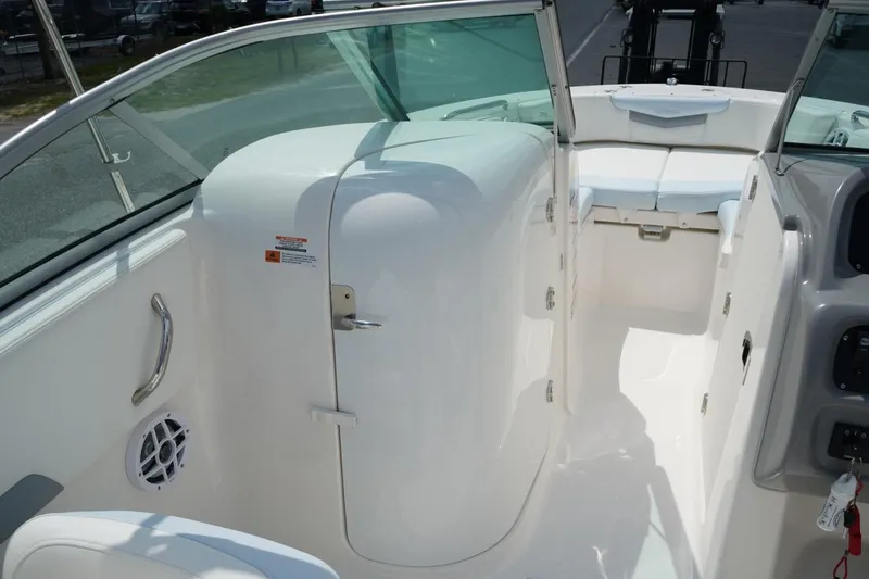 Slide: The Image of 2025 Robalo R207 Dual Console interior with white seating and sleek design. - 8