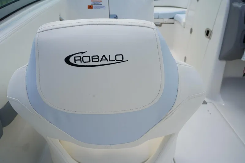 Slide: The Image of 2025 Robalo R207 Dual Console boat seat with logo, showcasing sleek design and comfort. - 13