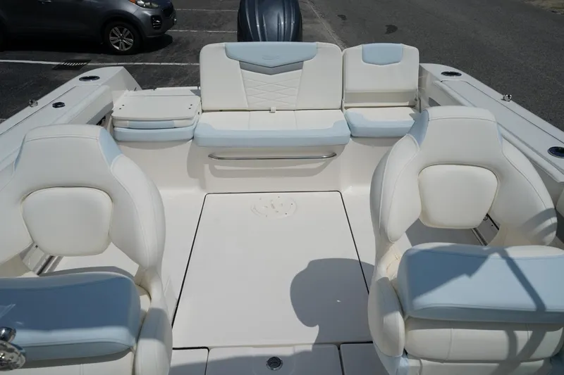 Slide: The Image of 2025 Robalo R207 Dual Console boat interior with white seating and modern design. - 4