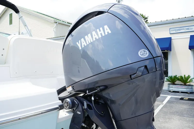 Slide: The Image of 2025 Robalo R207 Dual Console with Yamaha outboard motor, parked outdoors. - 17
