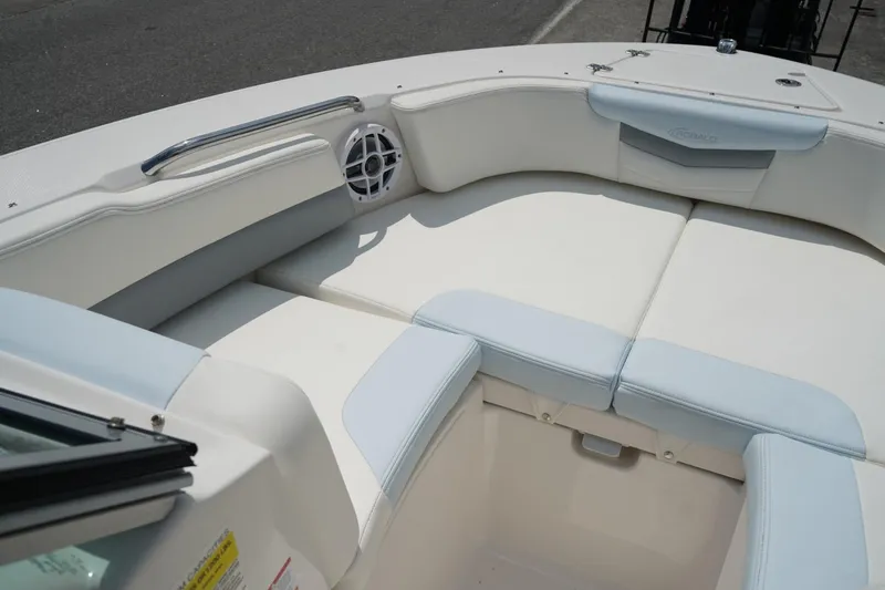 Slide: The Image of 2025 Robalo R207 Dual Console boat interior with cushioned seating and speaker. - 6