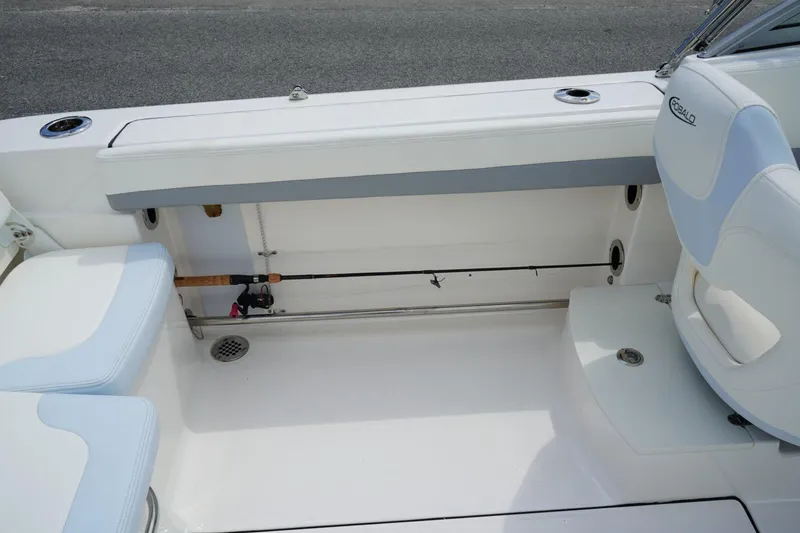 Slide: The Image of 2025 Robalo R207 Dual Console boat interior with seating and fishing rod holder. - 12