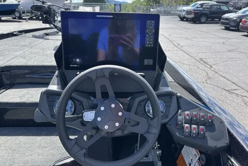 Slide: The Image of 2026 Skeeter ZXE20 boat dashboard with steering wheel and digital display. - 28