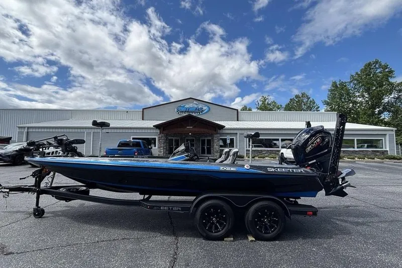 The Image of 2026 Skeeter ZXE20 boat parked outside a dealership under a partly cloudy sky. - 2