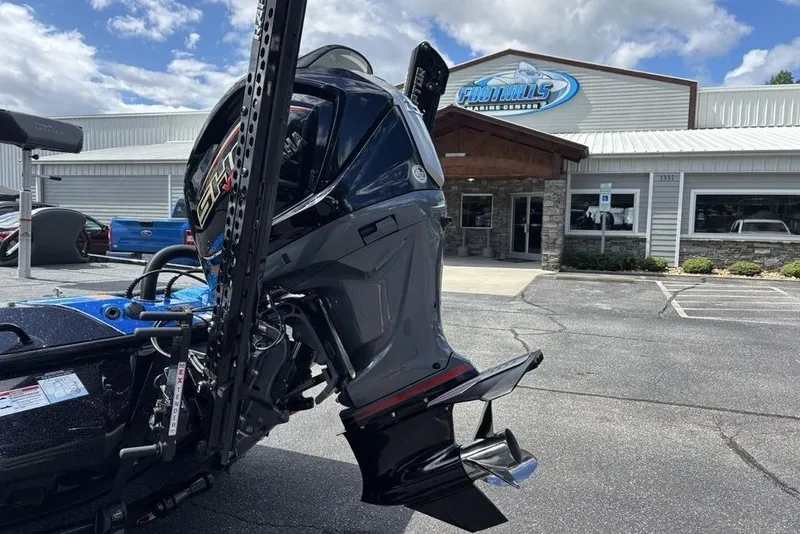Slide: The Image of 2026 Skeeter ZXE20 boat motor outside dealership under cloudy sky. - 5