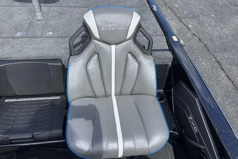 Slide: The Image of Skeeter ZXE20 2026 boat seat with sleek gray design and white stripe. - 25