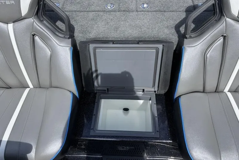Slide: The Image of 2026 Skeeter ZXE20 boat interior with open storage compartment between seats. - 26
