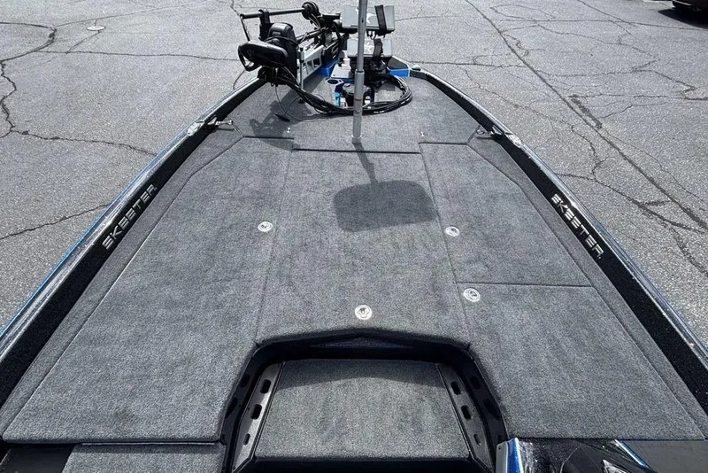 Slide: The Image of 2026 Skeeter ZXE20 boat deck with trolling motor, featuring spacious carpeted surface. - 20