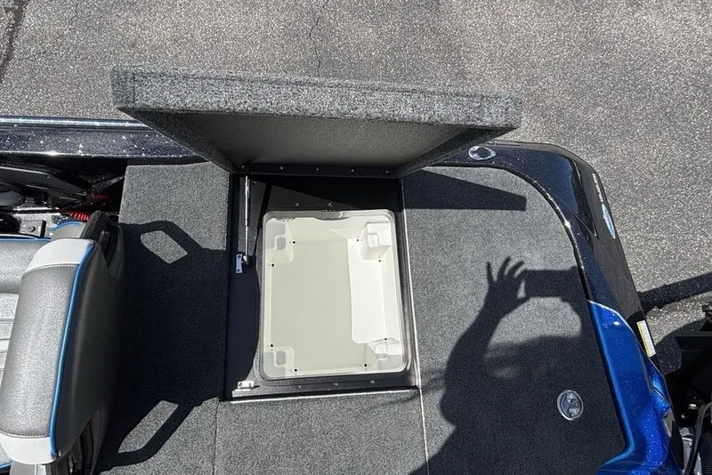 Slide: The Image of Open storage compartment on 2026 Skeeter ZXE20 boat, featuring carpeted deck and seating. - 41