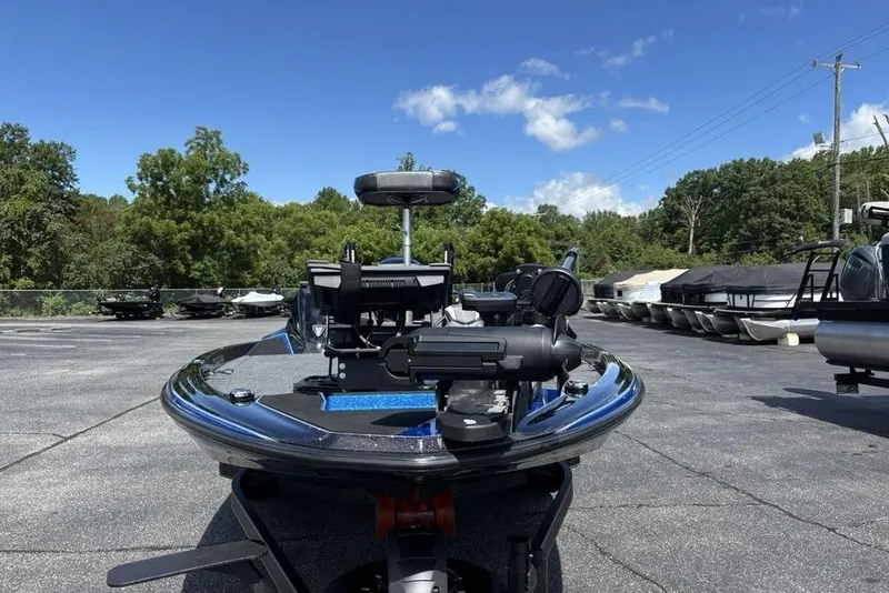 Slide: The Image of 2026 Skeeter ZXE20 boat parked outdoors under a clear blue sky. - 49