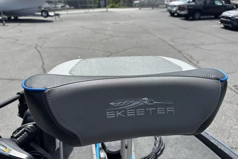 Slide: The Image of 2026 Skeeter ZXE20 boat seat with logo, parked in outdoor lot. - 19