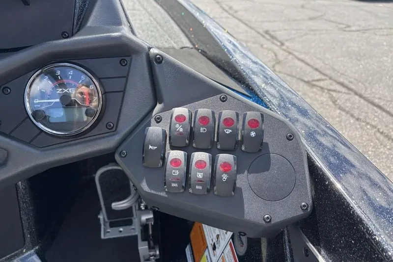 Slide: The Image of Dashboard controls of a 2026 Skeeter ZXE20 boat with switches and gauge. - 33