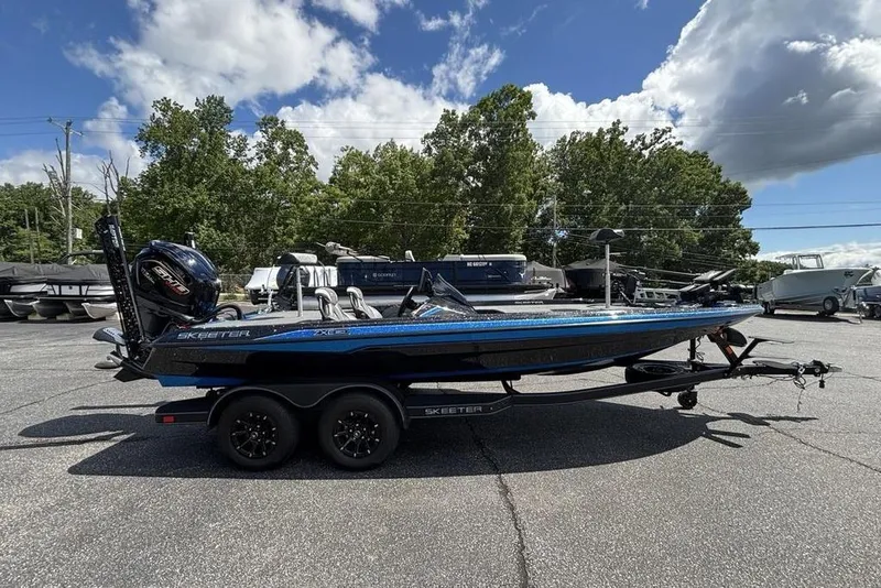 Slide: The Image of 2026 Skeeter ZXE20 boat on trailer, parked outdoors under a partly cloudy sky. - 51