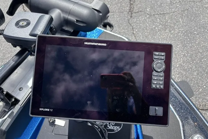 Slide: The Image of Humminbird Xplore 12 fishfinder on a 2026 Skeeter ZXE20 boat, reflecting cloudy sky. - 11