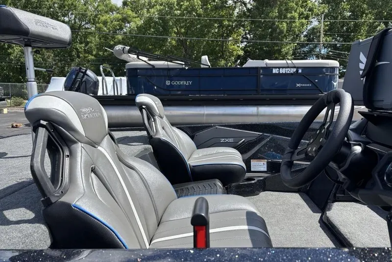 Slide: The Image of 2026 Skeeter ZXE20 boat interior with sleek seats and modern steering wheel design. - 52
