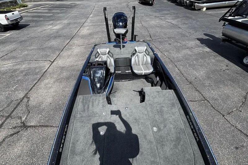 Slide: The Image of 2026 Skeeter ZXE20 boat with spacious deck and modern seating in a parking lot. - 45
