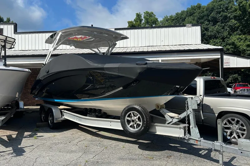 Slide: The Image of 2021 Yamaha Boats 275SD on trailer, parked outdoors near a building. - 8