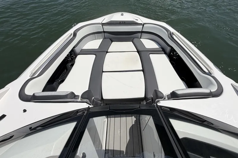 Slide: The Image of 2021 Yamaha Boats 275SD bow seating area on water, featuring sleek design and comfortable cushions. - 12
