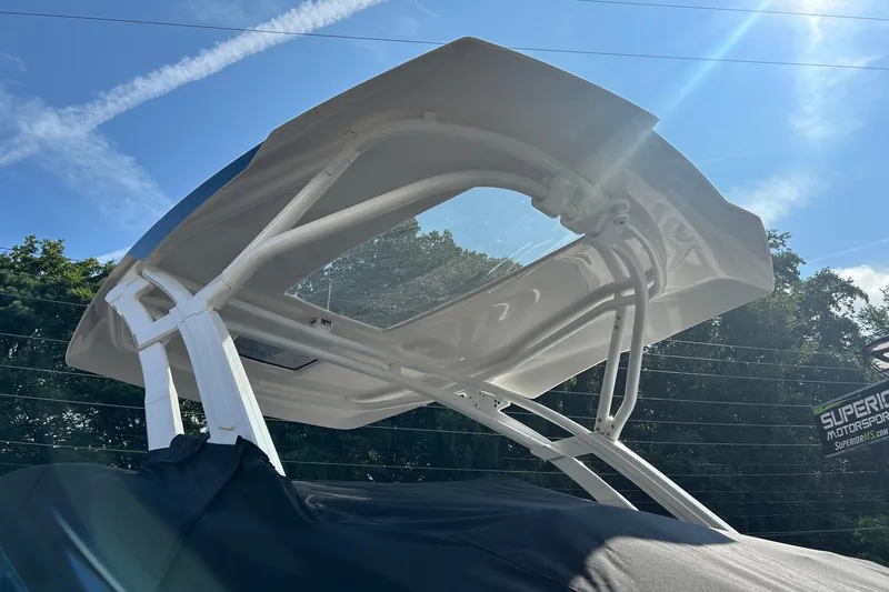 Slide: The Image of 2021 Yamaha Boats 275SD with sleek canopy against a clear blue sky. - 21