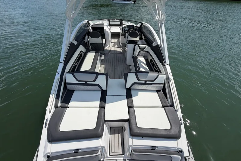 Slide: The Image of 2021 Yamaha Boats 275SD luxury interior with spacious seating on water. - 11