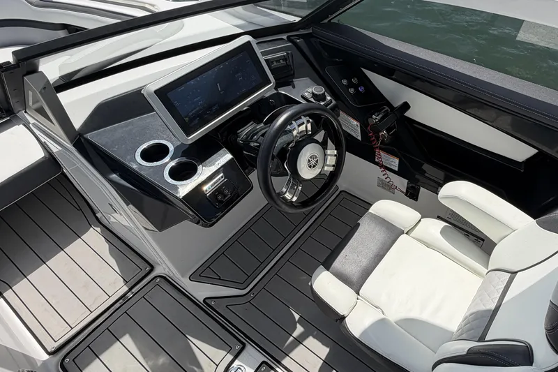 Slide: The Image of 2021 Yamaha Boats 275SD cockpit with modern steering and touchscreen display. - 14