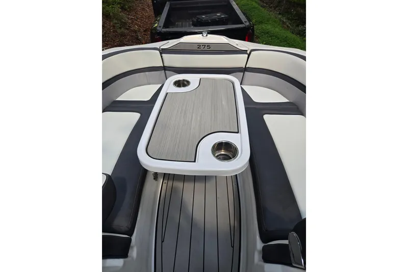 Slide: The Image of 2021 Yamaha Boats 275SD interior with table and seating area. - 18