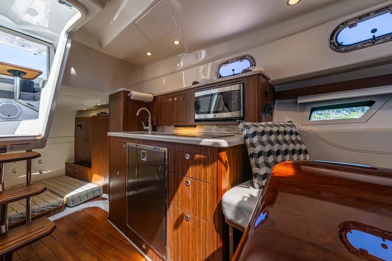 Slide: The Image of Luxurious interior of 2021 Pursuit OS 355 Offshore yacht with modern kitchen amenities. - 13