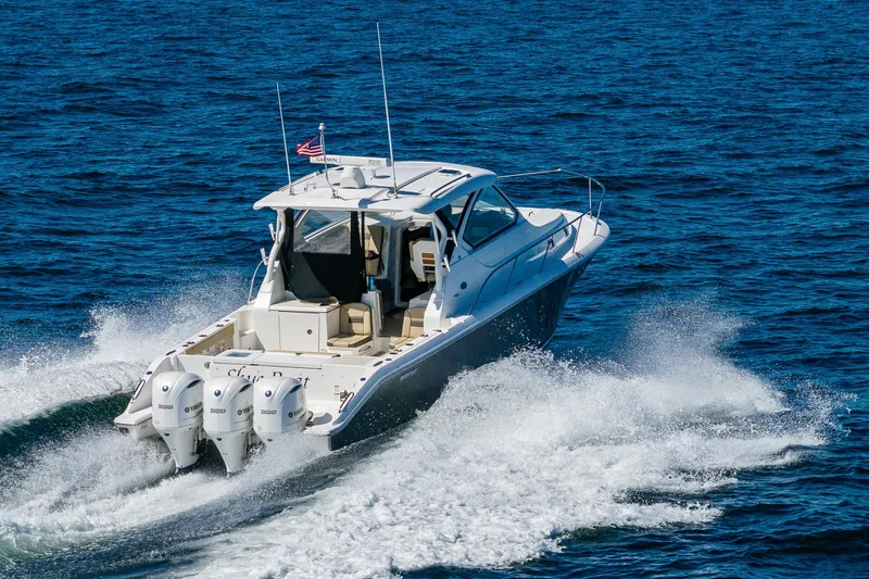Slide: The Image of 2021 Pursuit OS 355 Offshore boat cruising on open blue water. - 4
