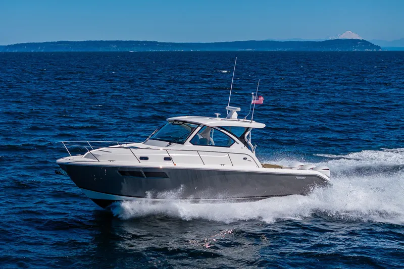 Slide: The Image of 2021 Pursuit OS 355 Offshore cruising on open water under clear blue skies. - 6