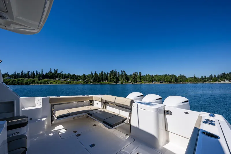 Slide: The Image of 2021 Pursuit OS 355 Offshore boat with spacious seating on a serene lake. - 21