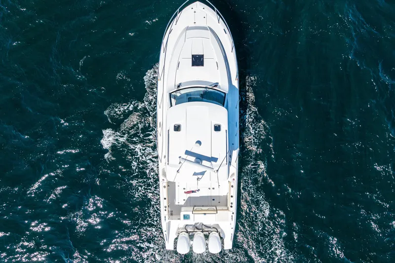Slide: The Image of Aerial view of 2021 Pursuit OS 355 Offshore boat cruising on open water. - 7