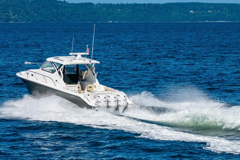 Slide: The Image of 2021 Pursuit OS 355 Offshore boat cruising on open water. - 5