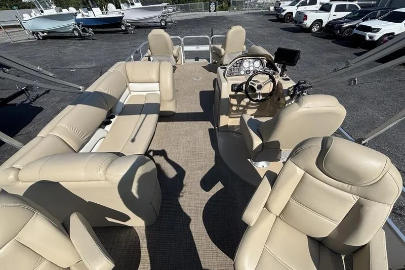 Slide: The Image of Interior of a 2016 SunChaser 8525 pontoon boat with beige seating and steering console. - 21