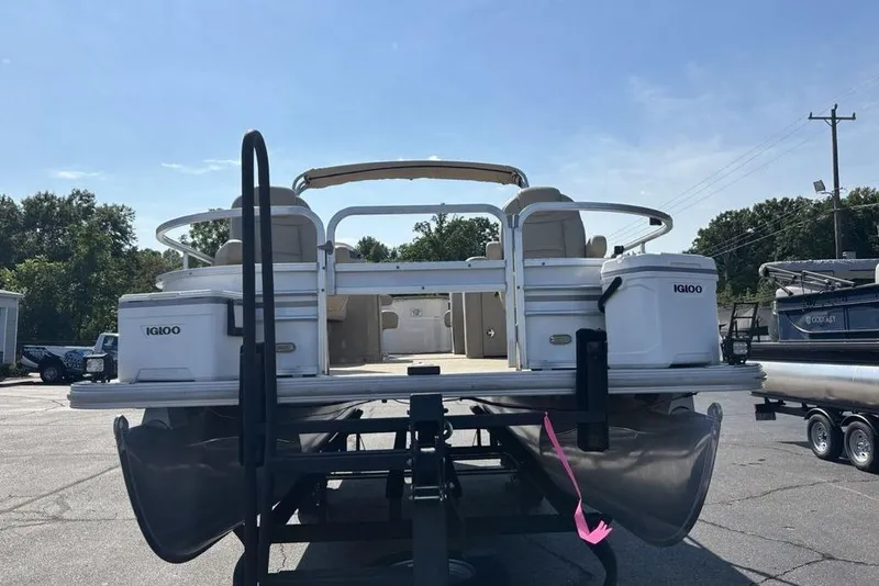 Slide: The Image of 2016 SunChaser 8525 pontoon boat on trailer, featuring Igloo coolers and spacious seating. - 23