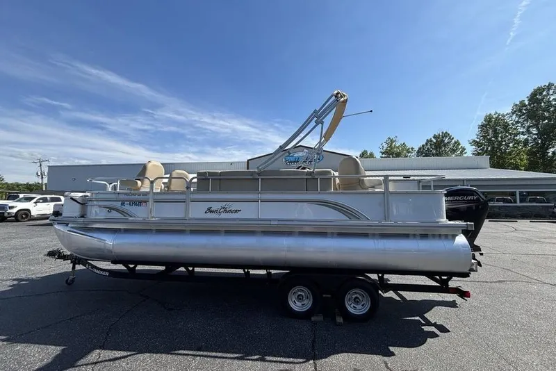 The Image of 2016 SunChaser 8525 pontoon boat on trailer, parked outdoors under clear sky. - 1