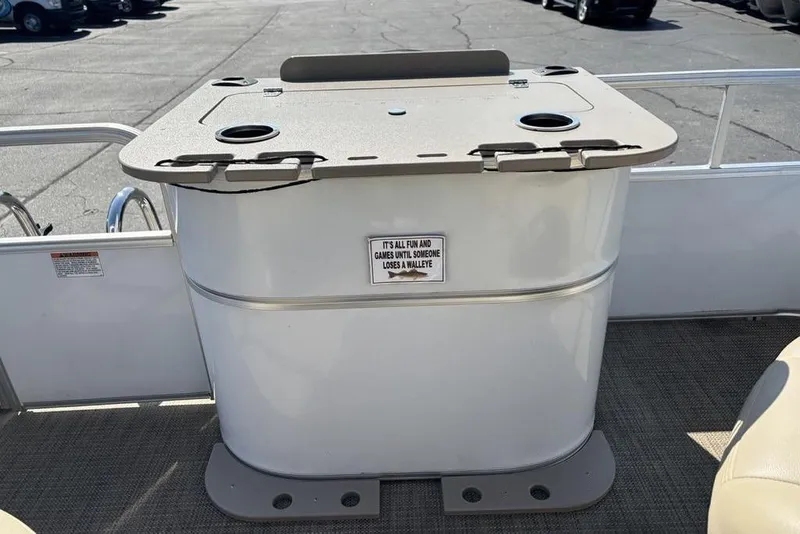Slide: The Image of 2016 SunChaser 8525 boat with a built-in storage compartment and cup holders on deck. - 20