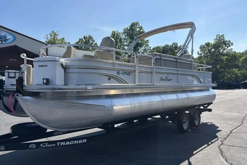 Slide: The Image of 2016 SunChaser 8525 pontoon boat on trailer, parked outdoors under clear sky. - 3