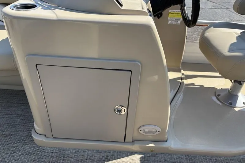 Slide: The Image of 2016 SunChaser 8525 boat console with storage compartment and cup holder. - 22