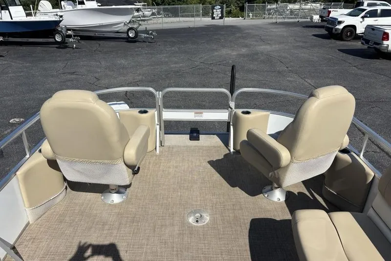 Slide: The Image of Pontoon boat deck with beige seats, SunChaser 8525, 2016 model, in a parking lot. - 7