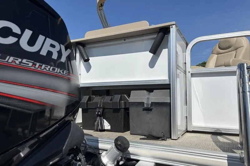 Slide: The Image of 2016 SunChaser 8525 pontoon boat with Mercury outboard motor, storage boxes, and seating. - 29