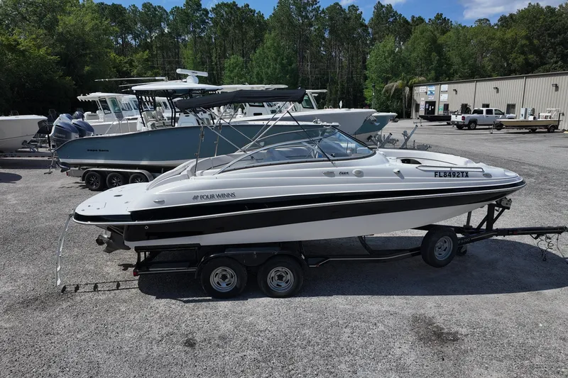 Slide: The Image of 2009 Four Winns F224 boat on trailer in outdoor storage area. - 1