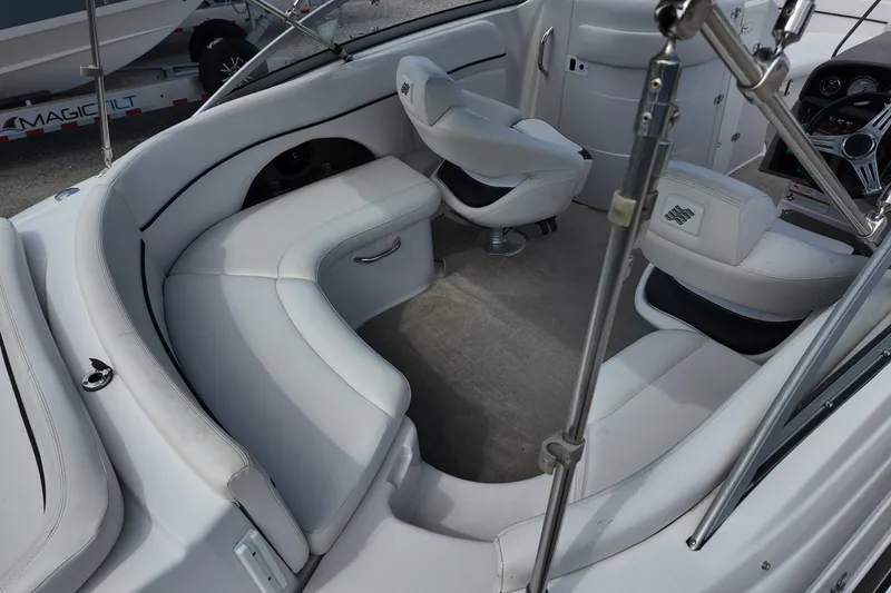 Slide: The Image of 2009 Four Winns F224 boat interior with white seating and steering wheel. - 5