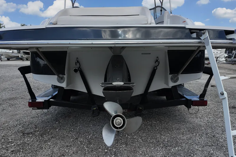 Slide: The Image of Rear view of a 2009 Four Winns F224 boat on a trailer, showcasing the propeller. - 22