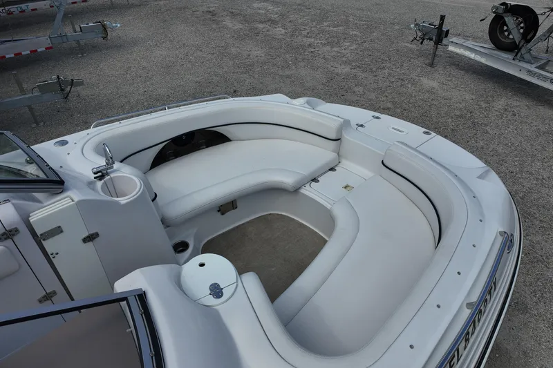 Slide: The Image of 2009 Four Winns F224 boat interior with white seating and cup holders. - 7