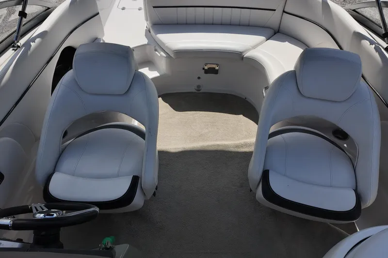 Slide: The Image of Interior of 2009 Four Winns F224 boat with white seating and steering wheel. - 17