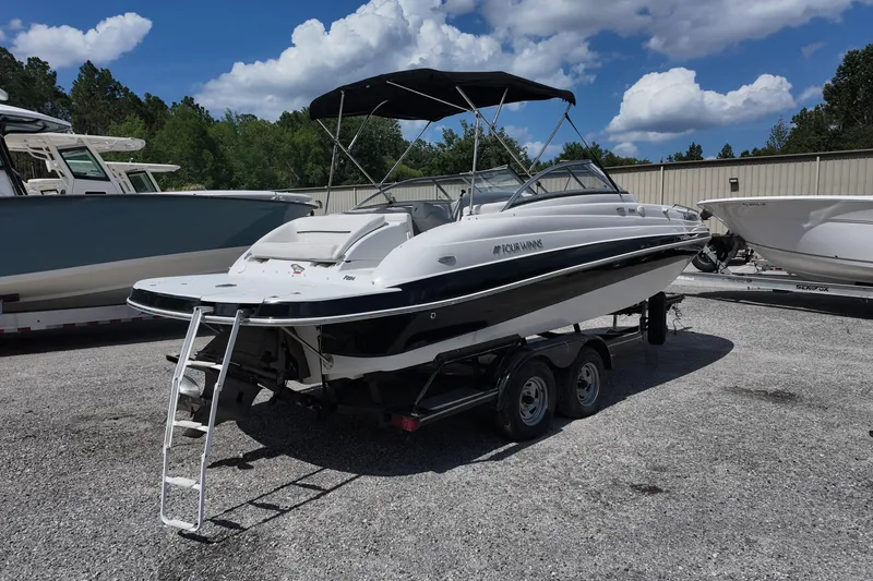 Slide: The Image of 2009 Four Winns F224 boat on trailer, parked outdoors under a blue sky. - 3