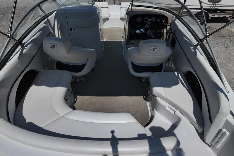 Slide: The Image of 2009 Four Winns F224 boat interior with white seating and steering console. - 20