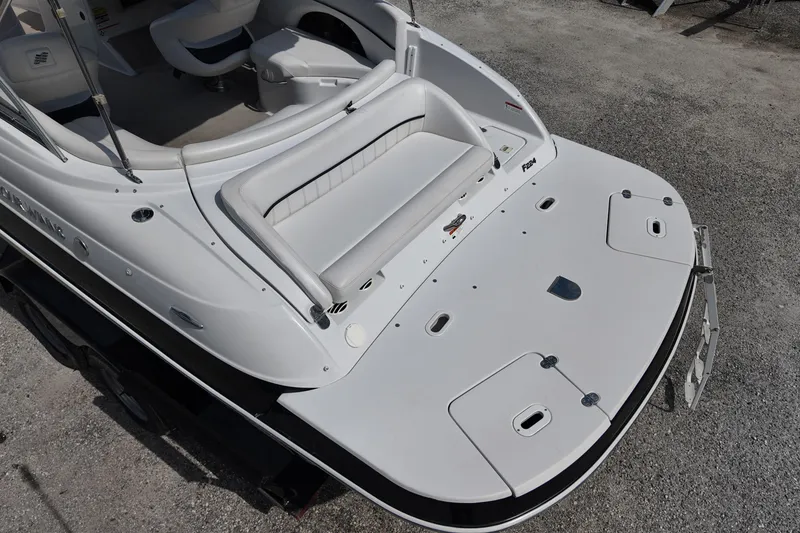 Slide: The Image of 2009 Four Winns F224 boat, white deck, spacious seating, and swim platform. - 12
